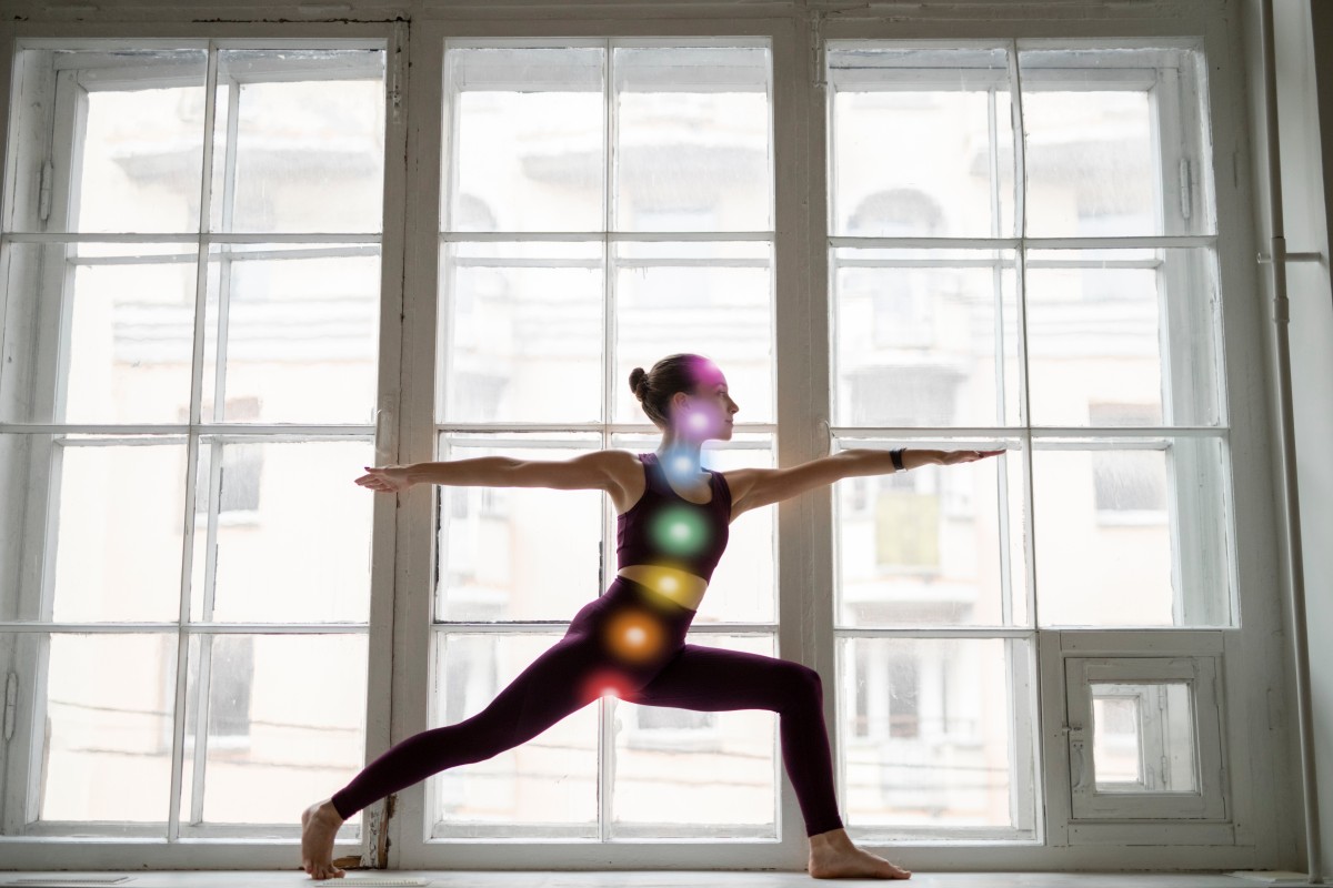 Young woman meditating with chakras her body (1)